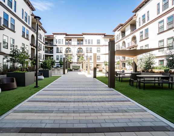 Central Courtyard with BBQs, Fireplace, Outdoor Kitchen and Green Space for Recreation