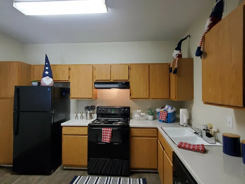 Black appliances in unit kitchen at Granada