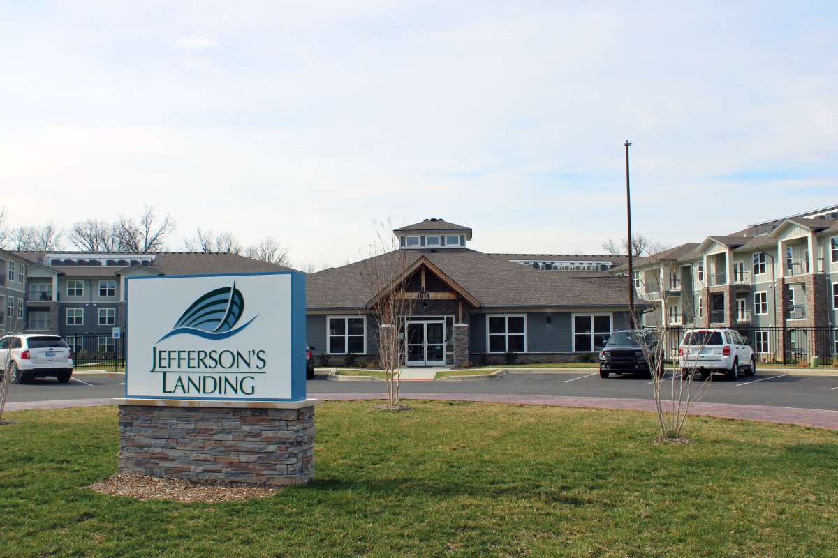 Exterior of apartments surrounded by green landscape at Jefferson's Landing in Louisville, Kentucky