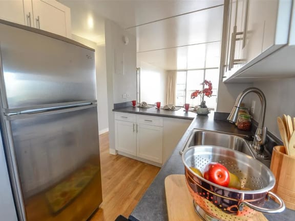 a kitchen with a stainless steel refrigerator and a sink at Waikele Towers, Waipahu, 96779