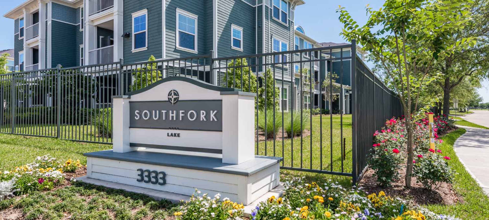 Apartment exterior view with signboard at Southfork Lake in Manvel, Texas 