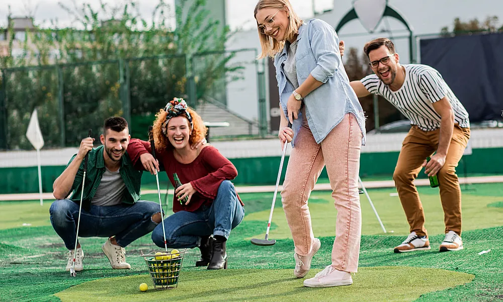 group of friends playing mini golf