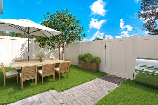fenced backyard with outdoor seating at Pearl at Pompano Beach pet friendly homes