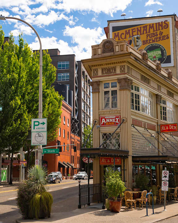A street view of a city with a building that has a sign that says "McChain's".