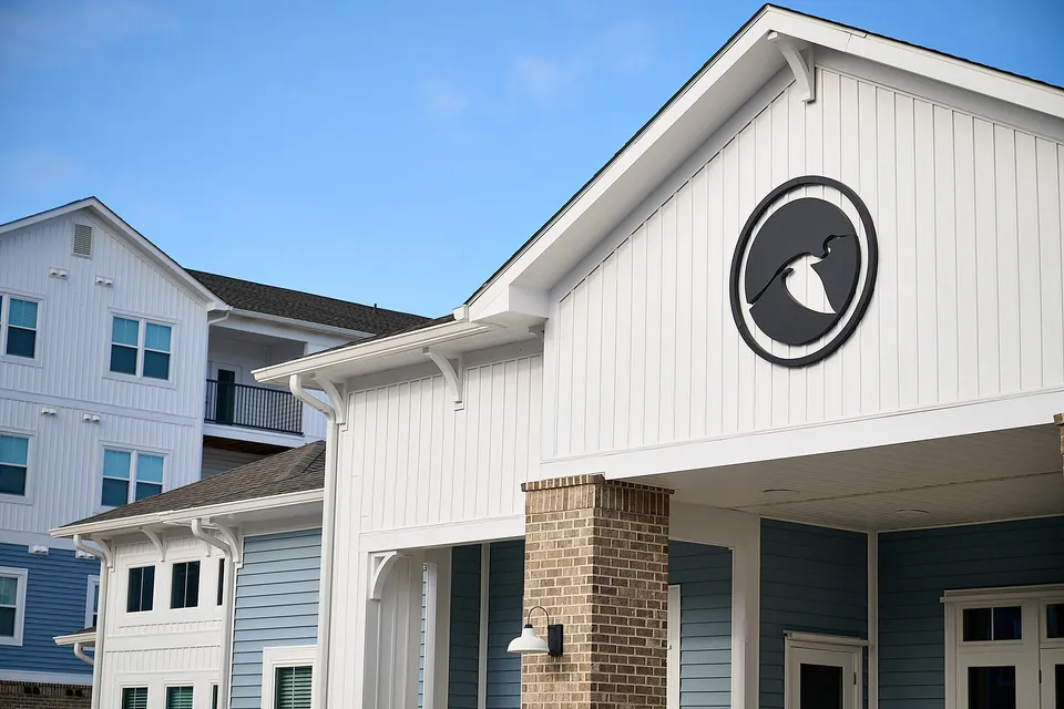Inviting apartment complex with modern architecture, featuring blue and white exteriors and stylish accents.