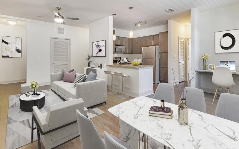 a large living room with a dining table and chairs