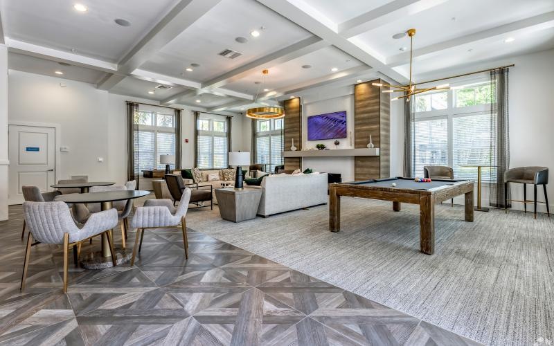 a clubroom with a pool table and chairs