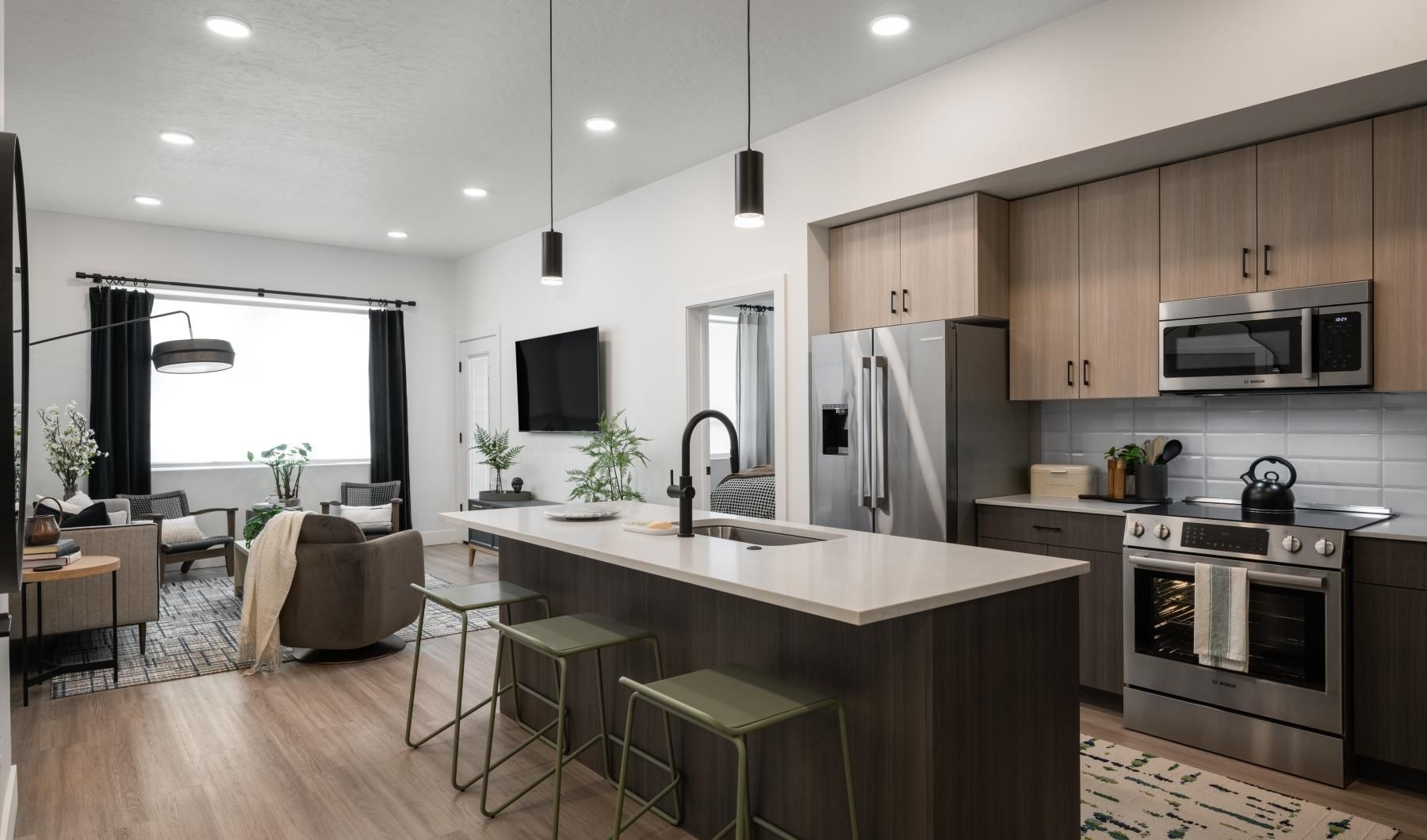 a kitchen with a bar stools and a large island