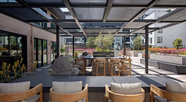 Outdoor grilling area with bar seating and modern seating