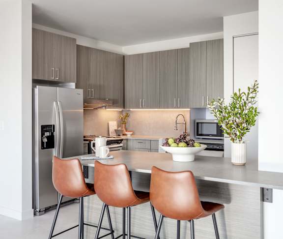 Kitchen with island and chairs at Lofts at Centennial Yards, Atlanta, Georgia