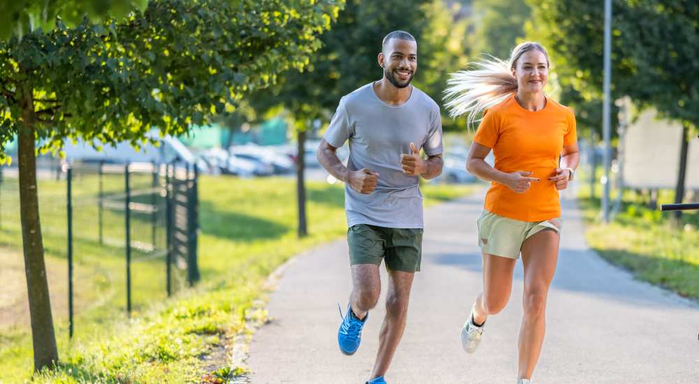 Residents couple jogging in park near Ironwood on North Salem in Apex, North Carolina