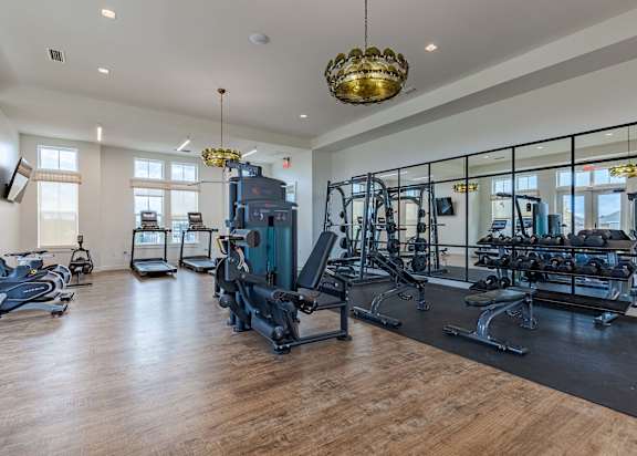 Fitness center at Outpost Orchard in Foley, AL, equipped with modern exercise machines and free weights.