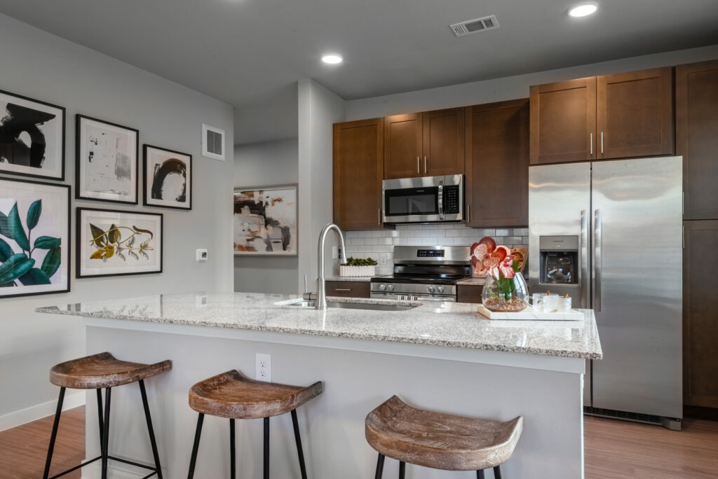 The Heart of Your Home - luxury apartment kitchen with granite countertops and stainless steel appliances