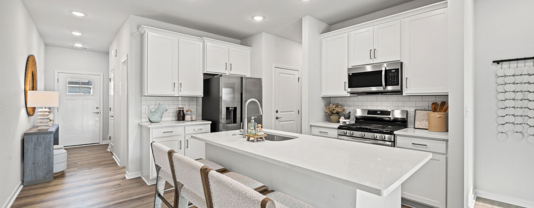 Entrance to home plus furnished kitchen with large island