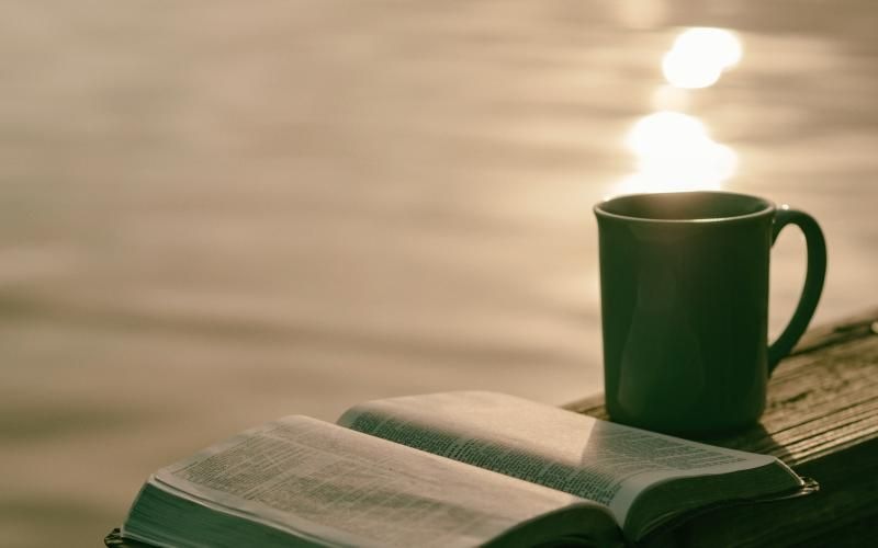 a green mug on a book