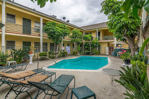 our apartments have a swimming pool and a patio with chairs