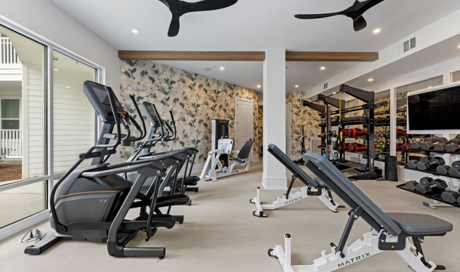 Fitness center with equipment and natural light 