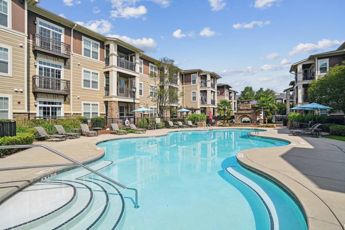 Swimming pool and lounge chairs at Fountains at Mooresville Town Square in Mooresville, North Carolina