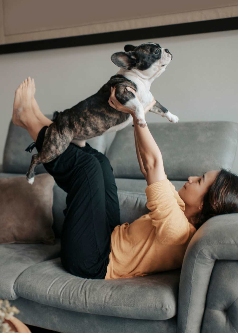 Resident with Her Dog in Couch at Pearl Lofts in Dallas, Texas