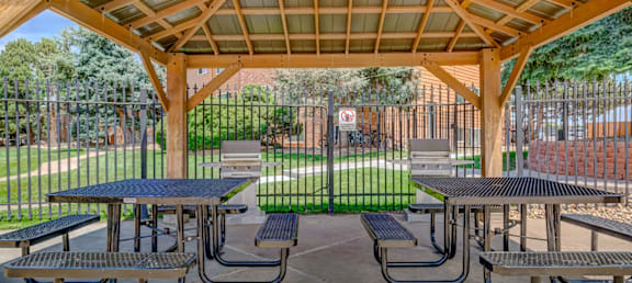 A covered picnic area with tables and benches.