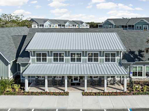 A large house with a grey roof and a covered patio at Standard441 Luxury Apartments, Lady Lake, FL, 32159