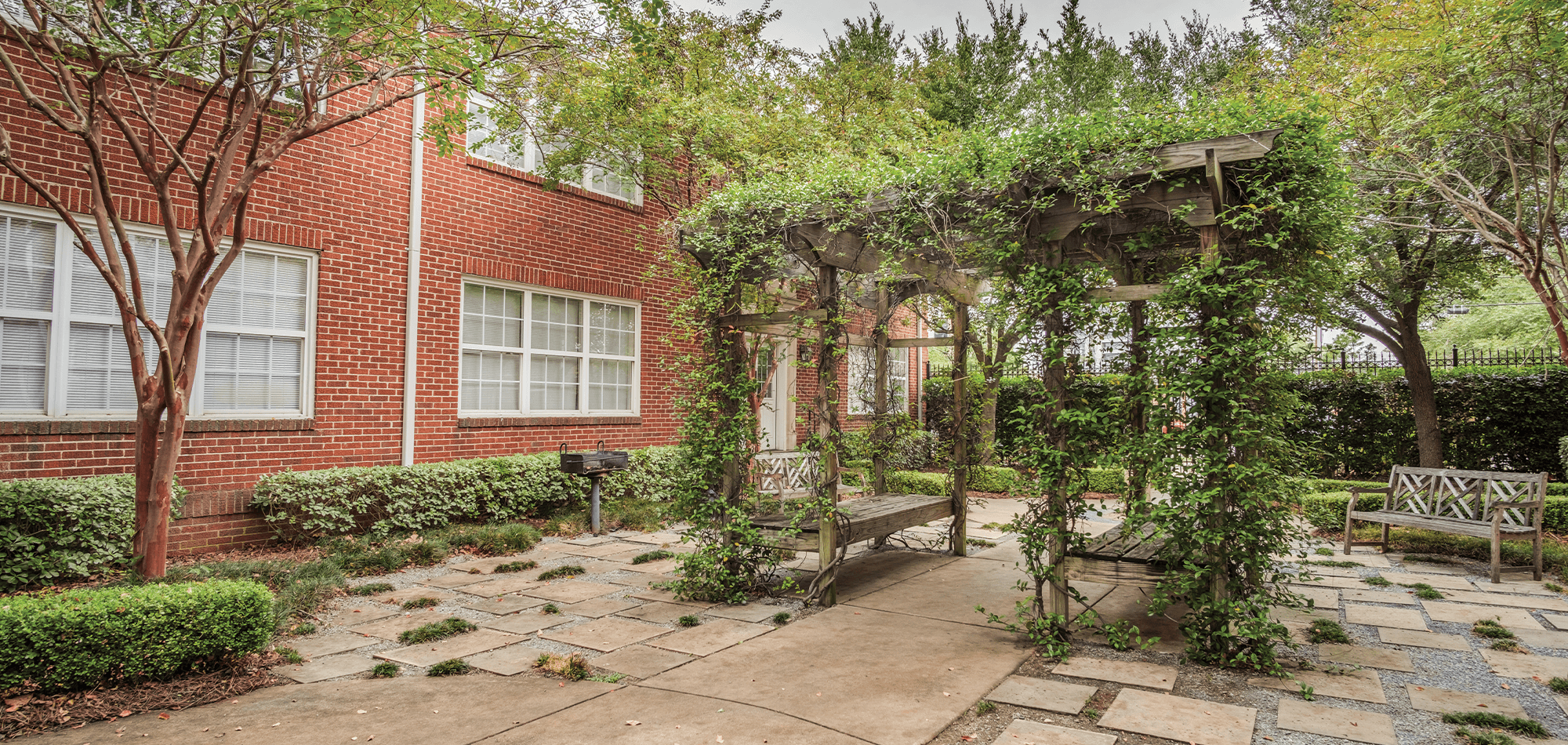 The vine covered sitting area of Adams Avenue Flats courtyard