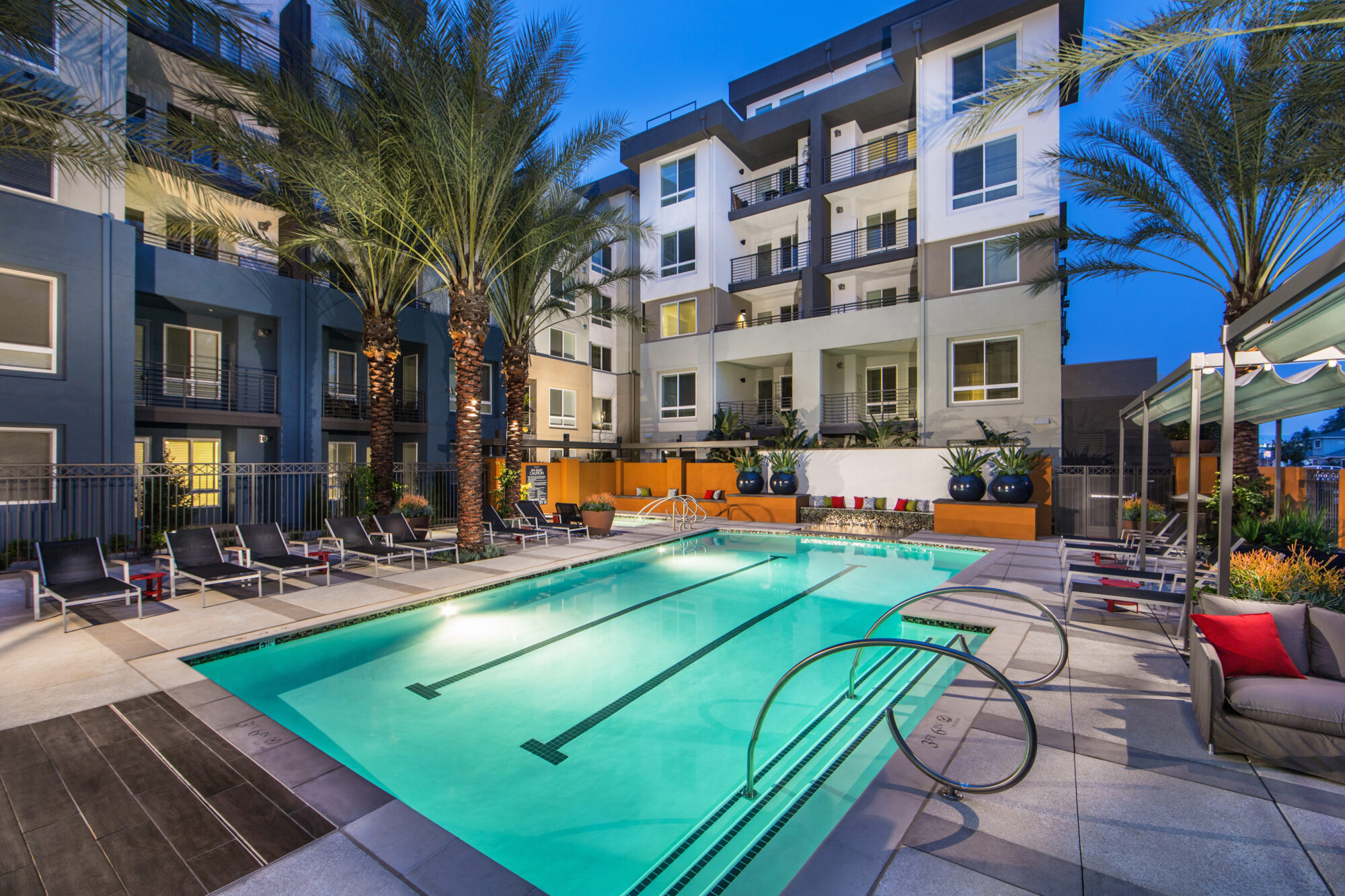 Pool with deck seating and cabanas