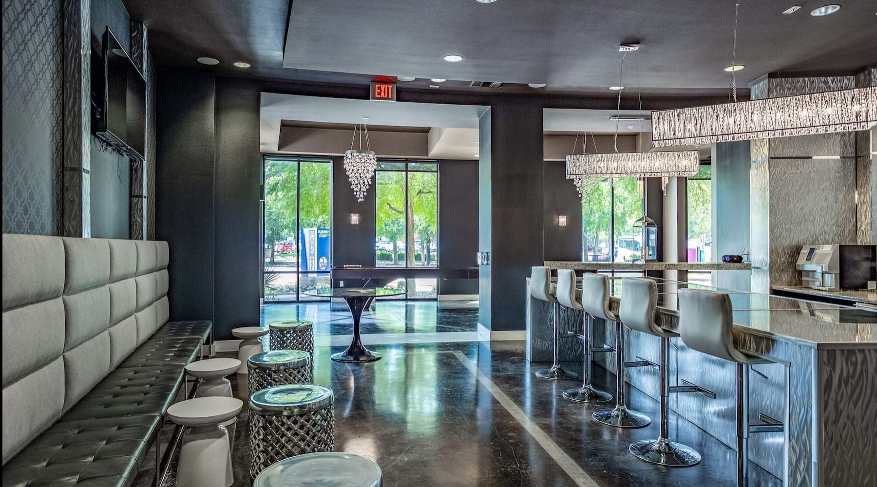 a room with a bar and chairs