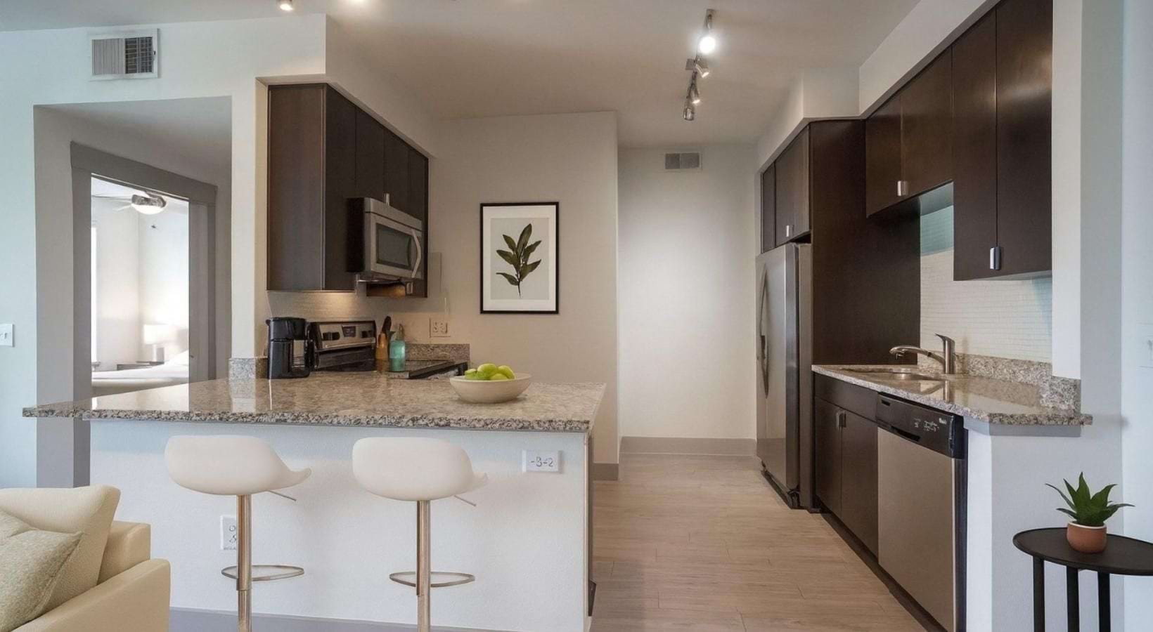 a kitchen with a marble island