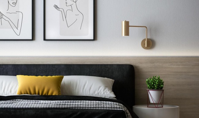 a bed with yellow and white pillows