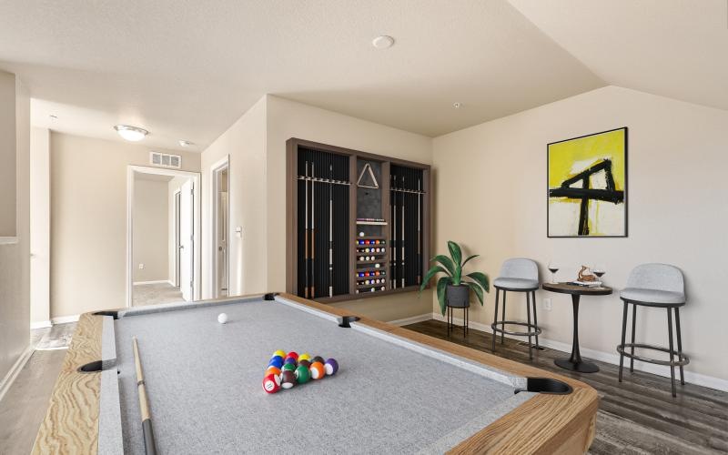 a lounge room with a pool table and chairs