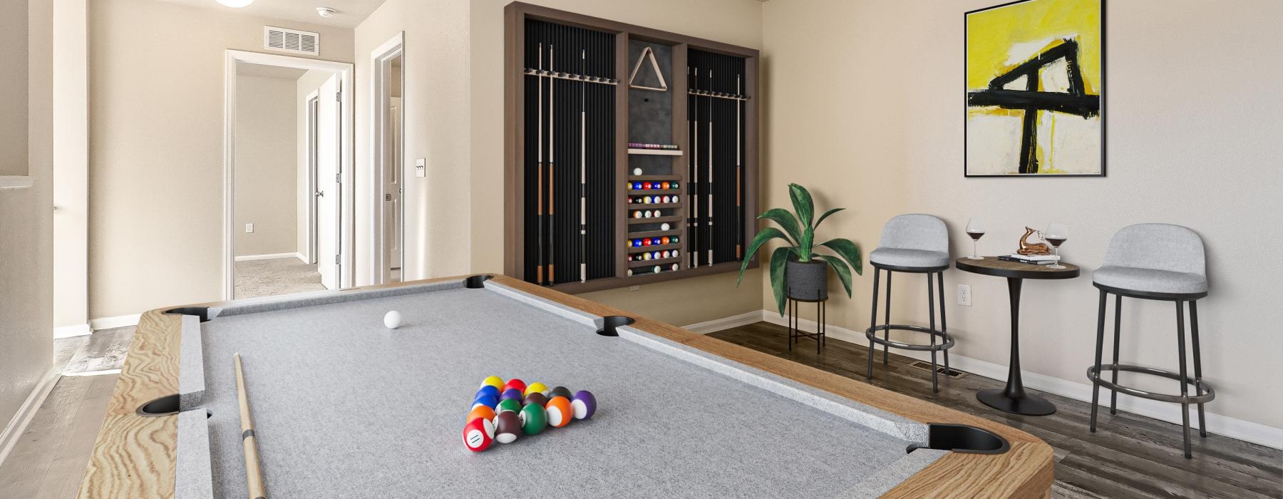 a lounge room with a pool table and chairs