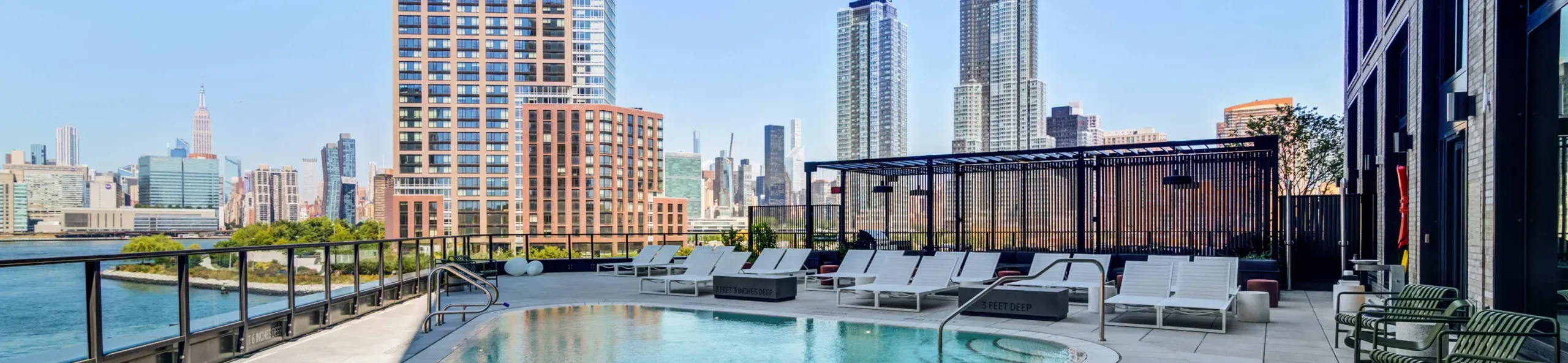 Rooftop pool at the hotel, surrounded by tall buildings, offering a serene escape in an urban setting.