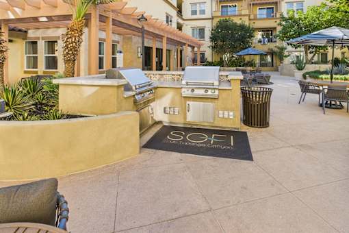 A courtyard with a hot tub and a sign that says "SOFI".