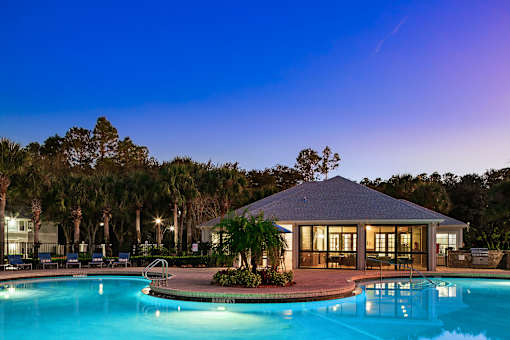 A pool with a house in the background.