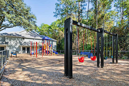 A playground with a swing set and a slide.