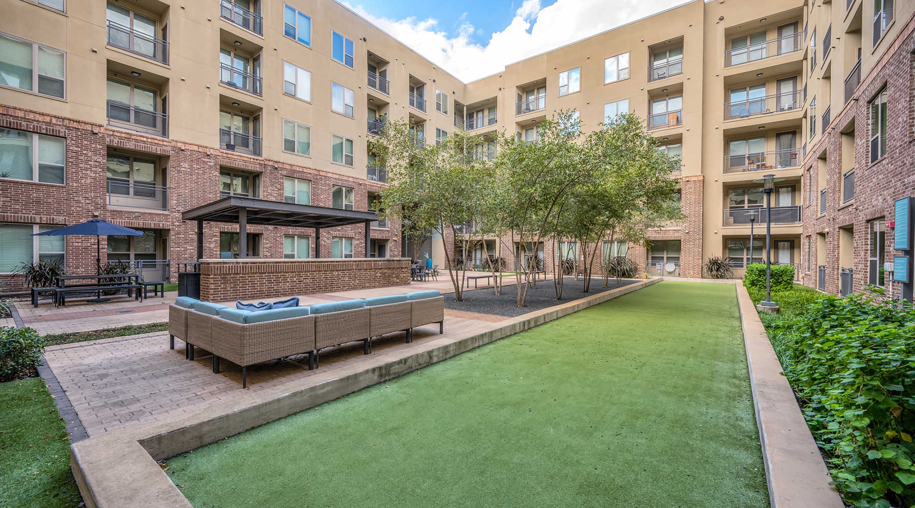 a courtyard with a pool and trees