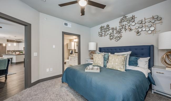 a bedroom with a bed and a fan