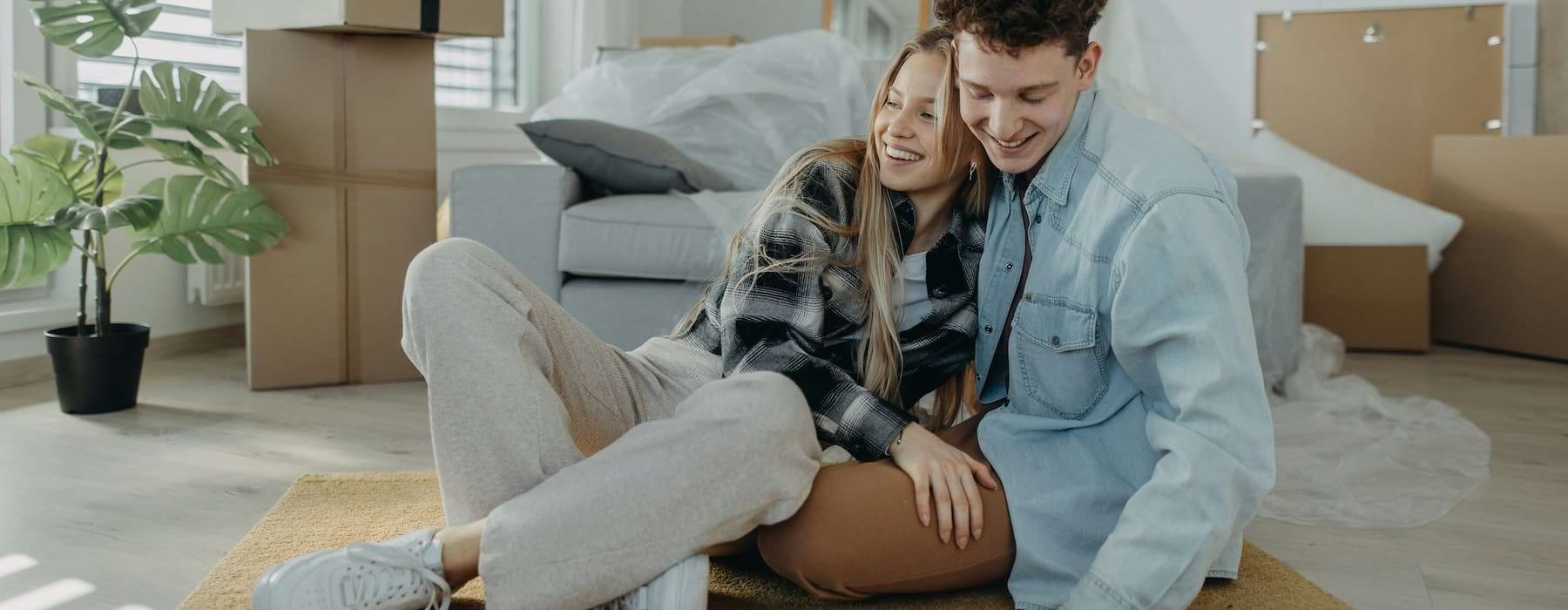 a man and a woman sitting on the floor