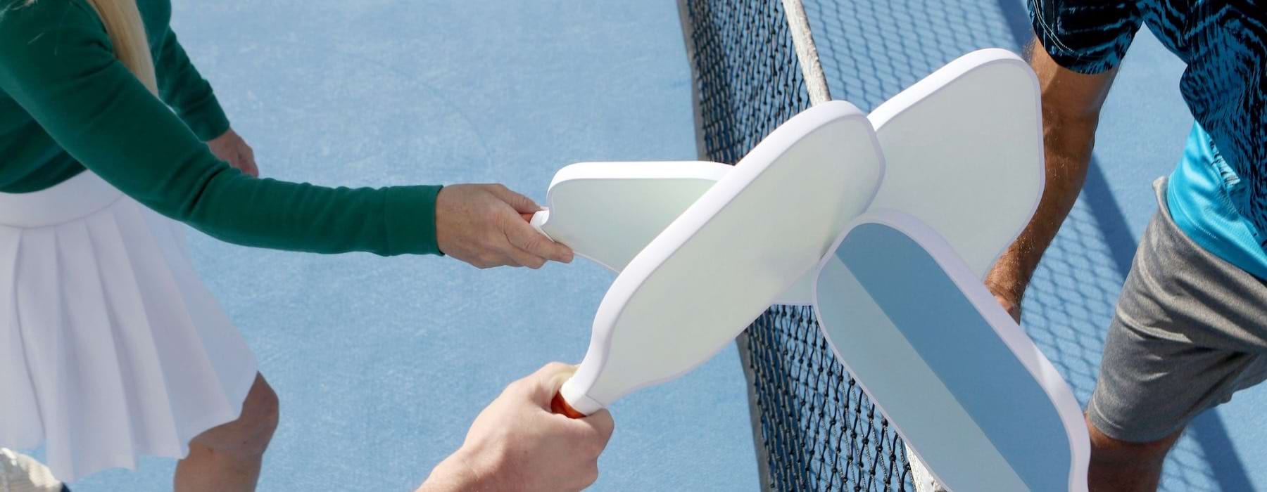 people holding paddles