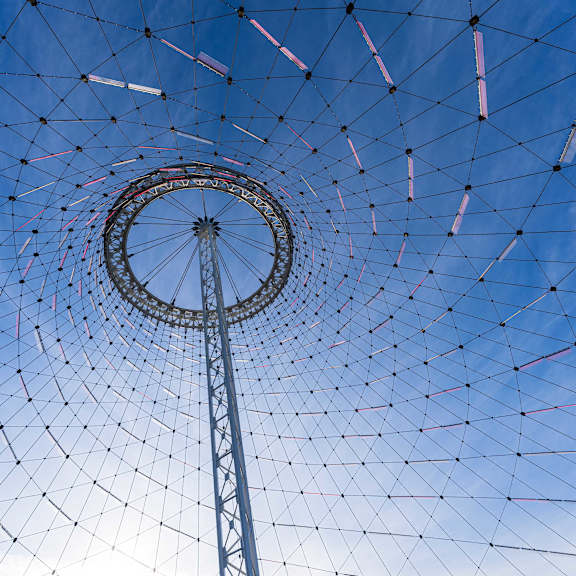 A Ferris wheel against a blue sky.