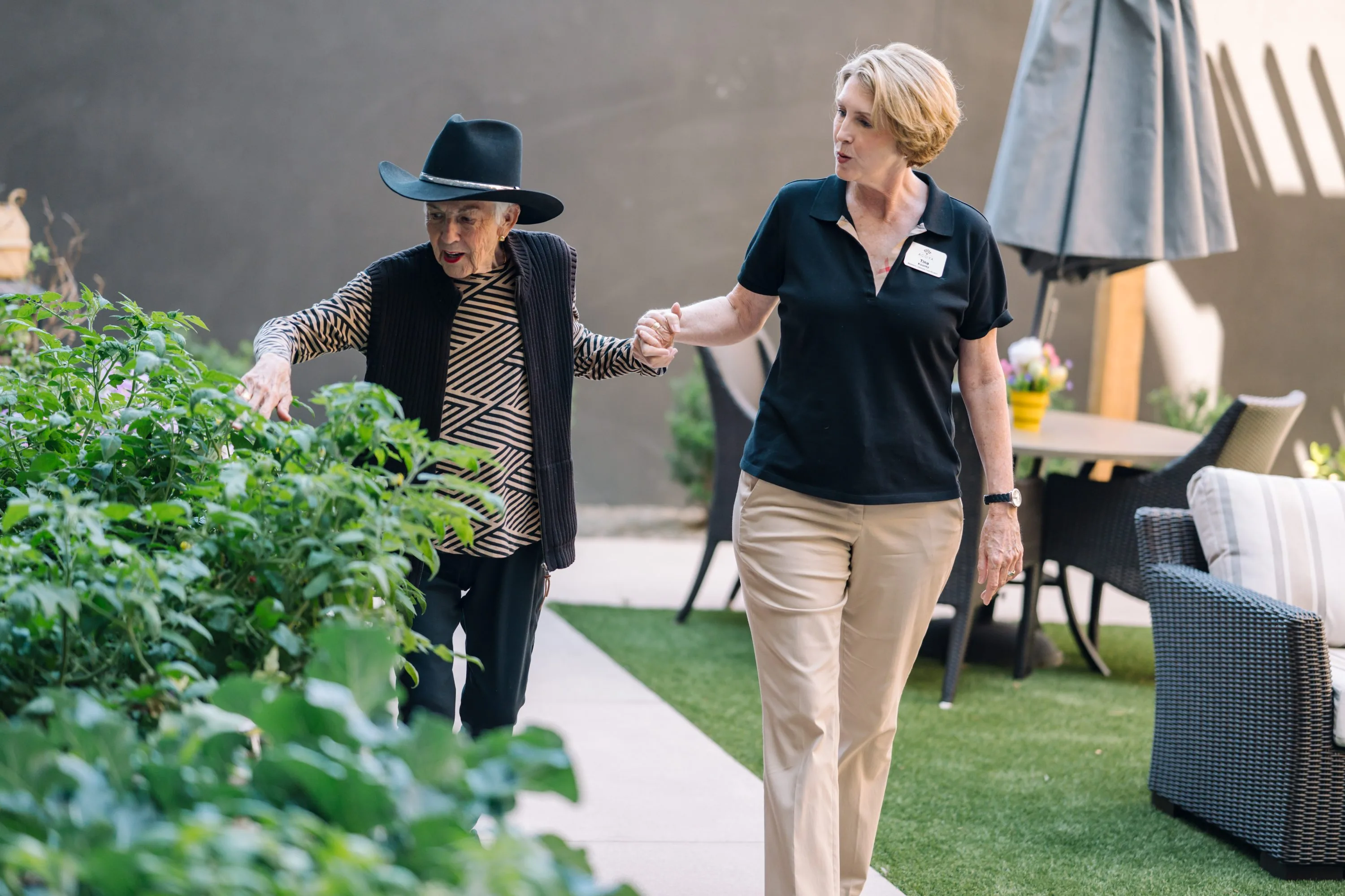 A vibrant garden stroll, showcasing a warm connection between residents and staff in a welcoming atmosphere.