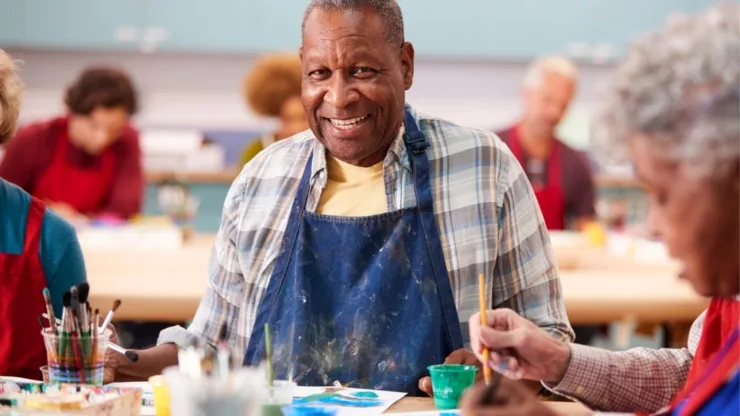 A vibrant art class brimming with laughter and creativity, showcasing engaged seniors sharing joyful moments.