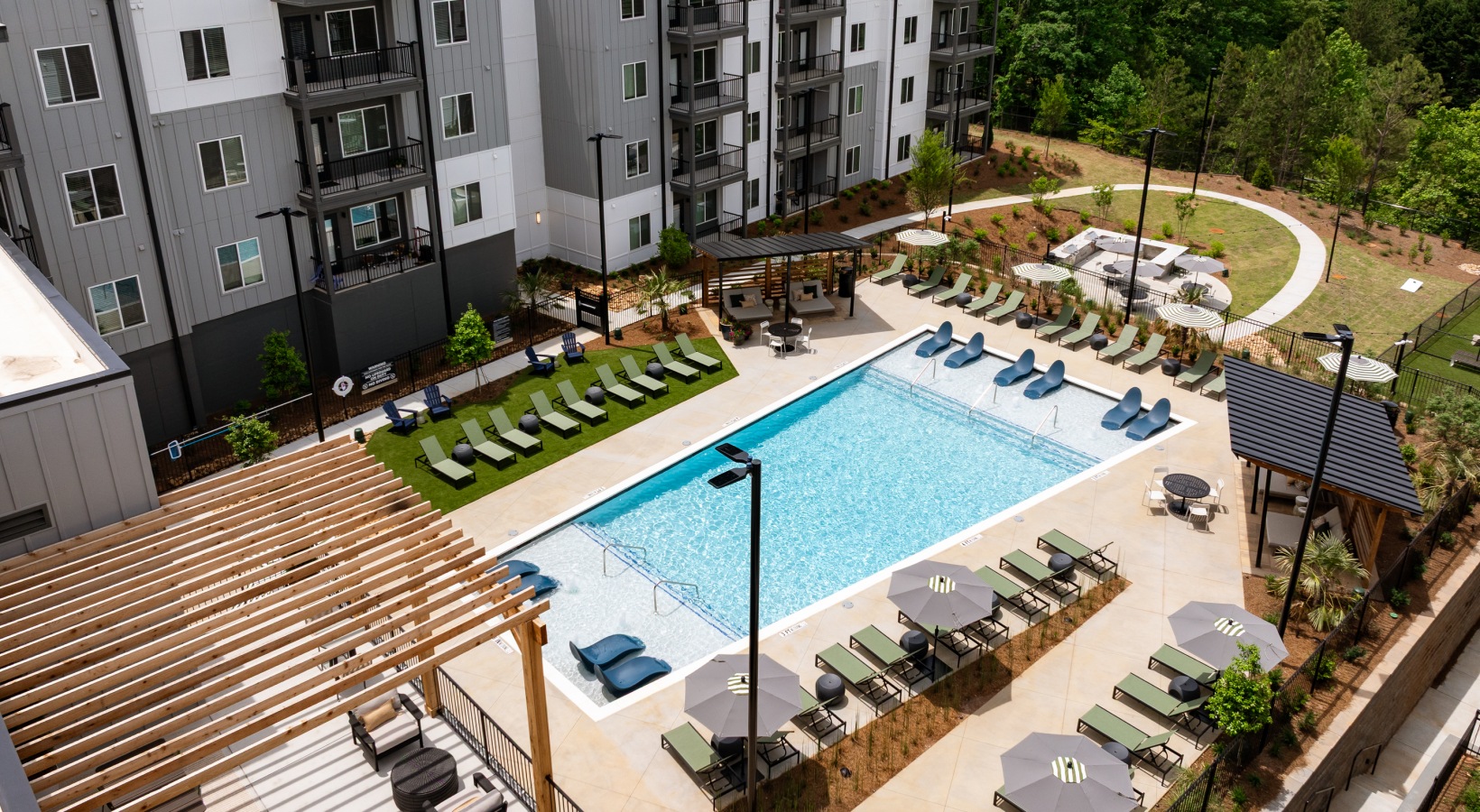 Resort-style pool with sundeck & pergolas at Ava Oakwood apartments in Gainesville, GA