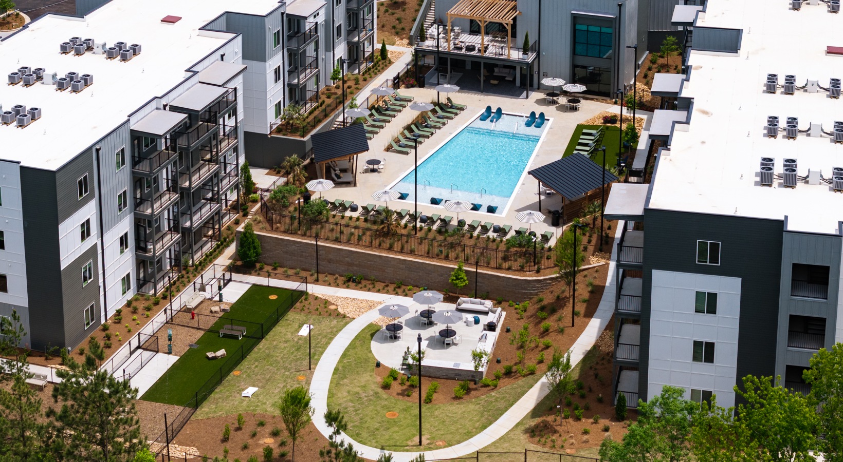 Resort-style pool with sundeck & pergolas at Ava Oakwood apartments in Gainesville, GA