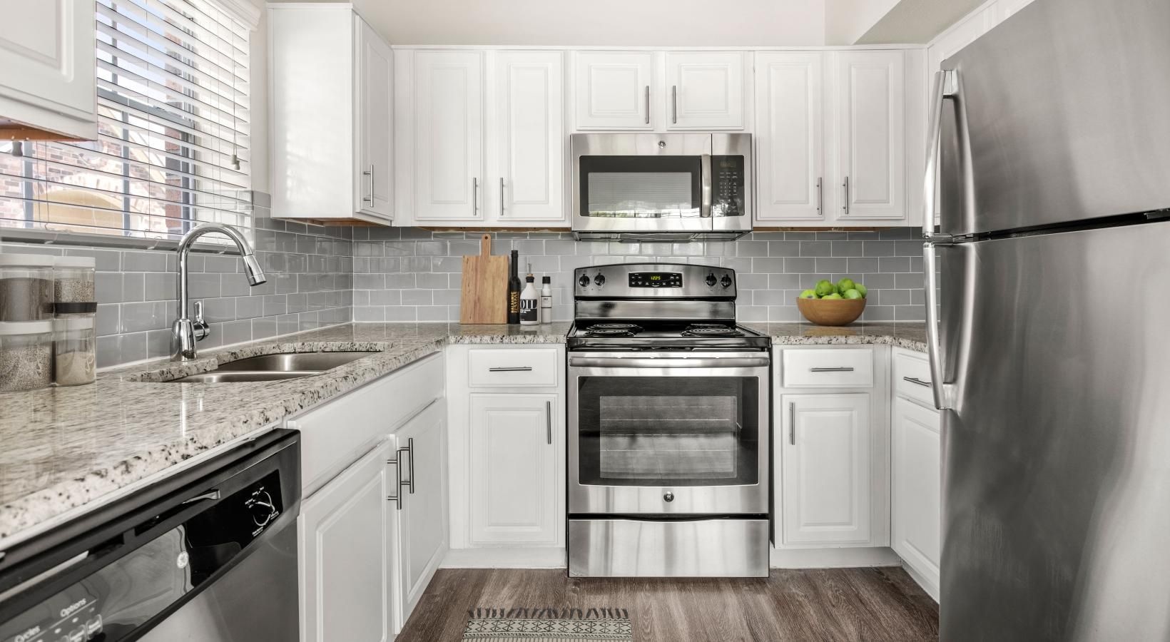 a kitchen with white cabinets