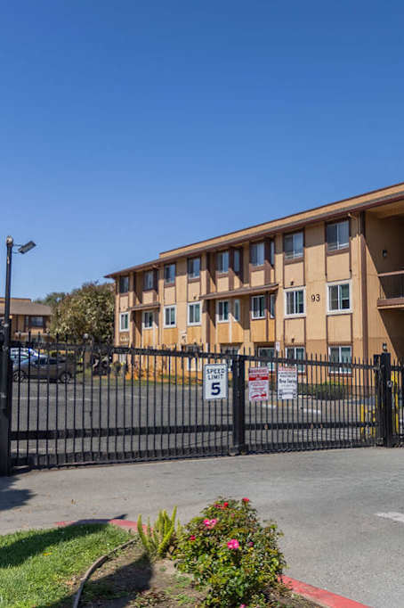 an apartment building with a fence and a gate