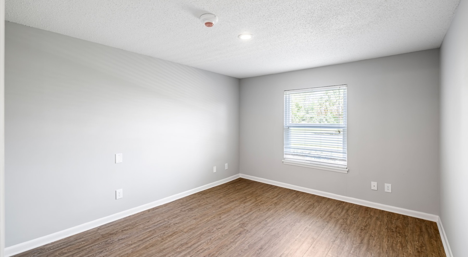 bedroom with hardwood floors and a window