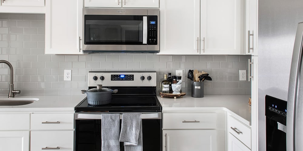 Beautiful kitchen with stainless-steel appliances in a model home at The Station at Fleming Island in Fleming Island, Florida
