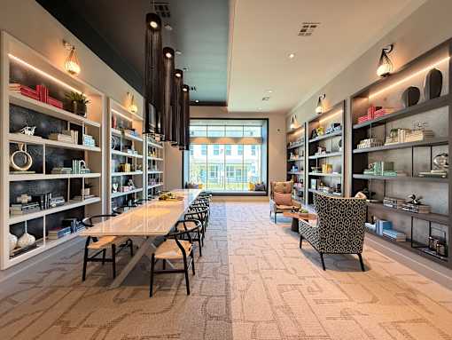 A modern interior with a long table and chairs.